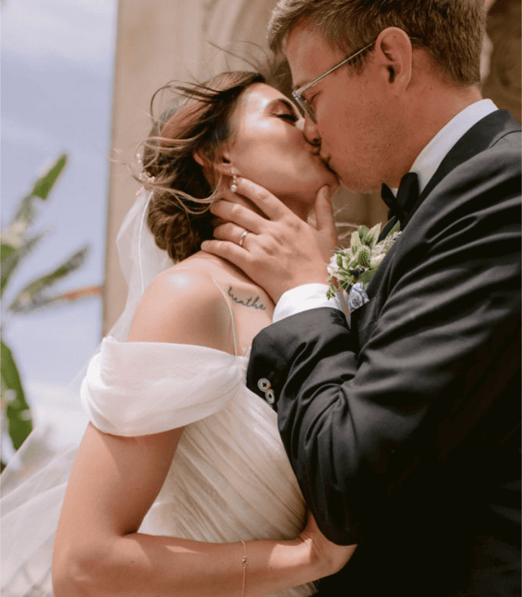 Bride and groom sharing a kiss during their wedding ceremony.