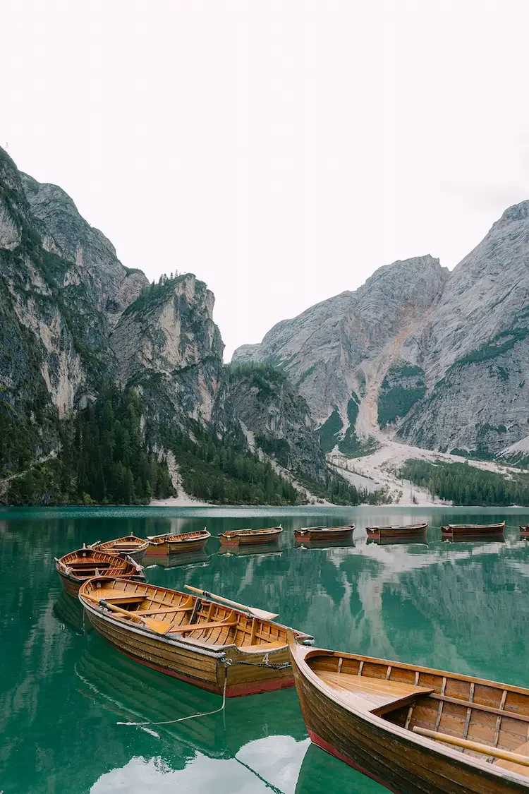 Lake with row boats in the Dolomites Italy