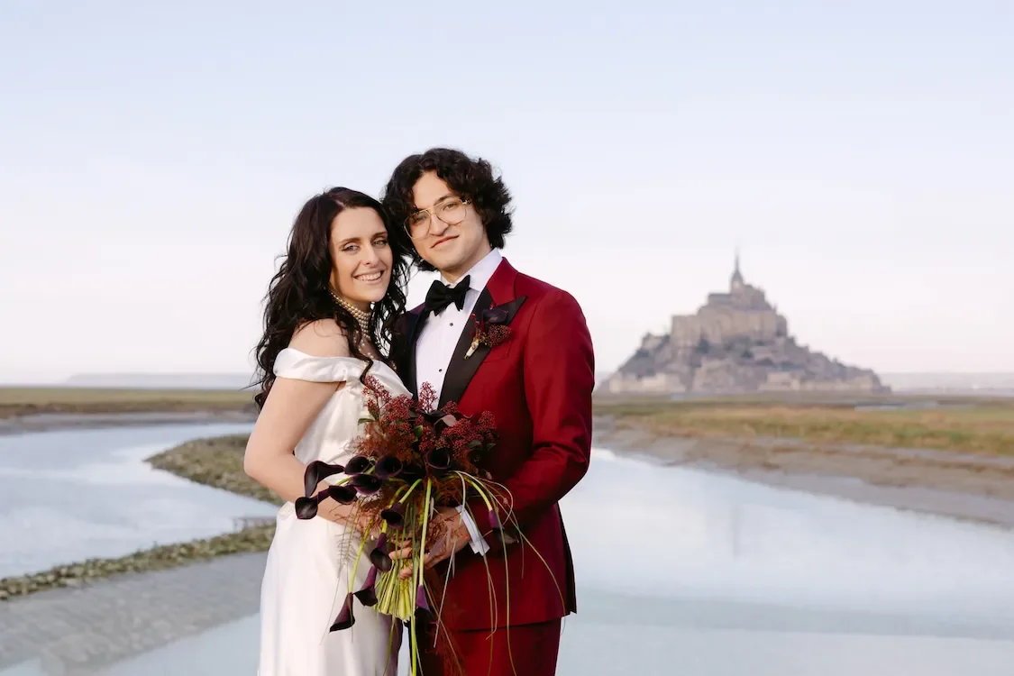 Coiple elopement portrait in Mont Sait Michel with castle in the background in France