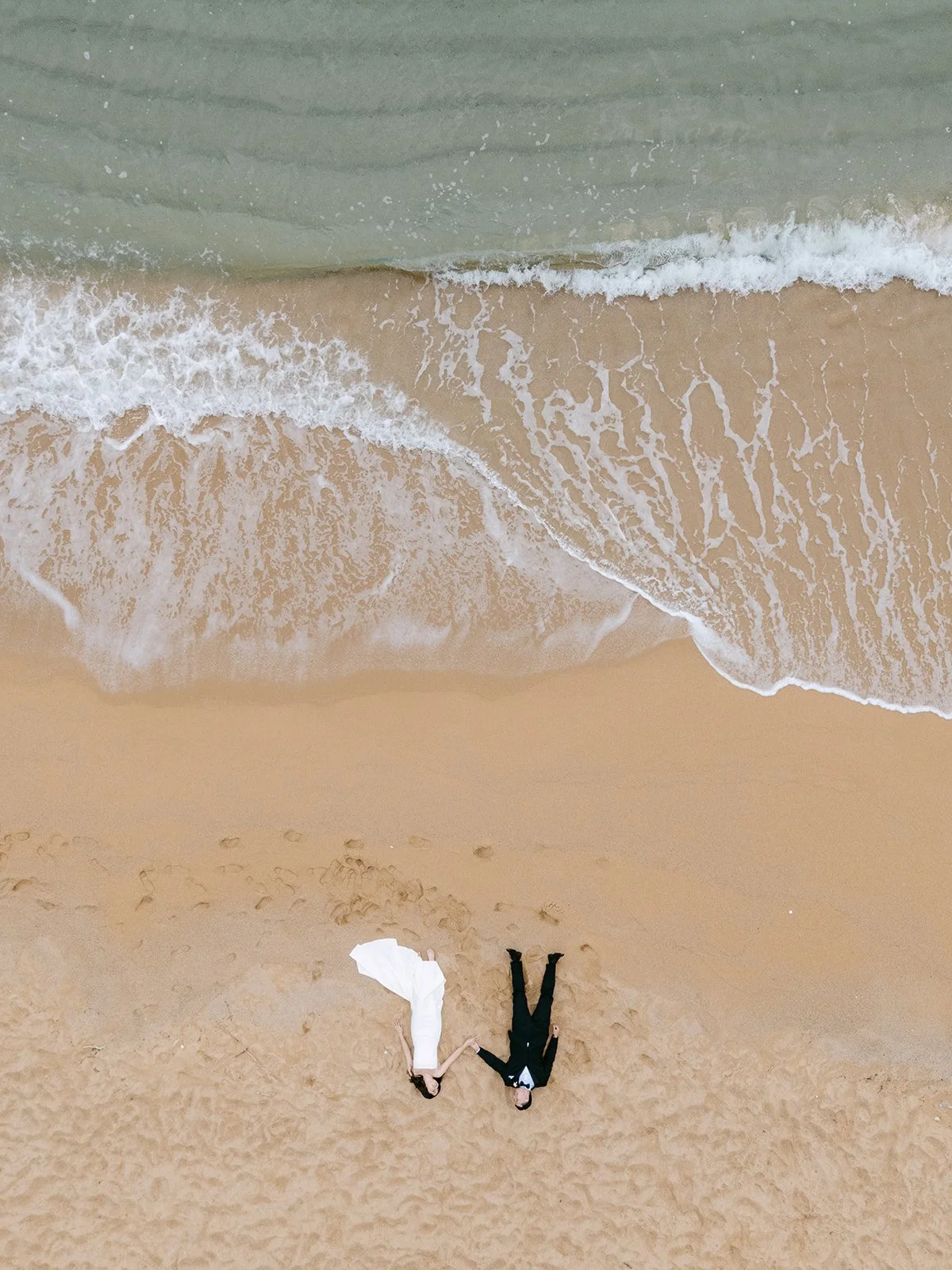 drone perspective elopement wedding portrait of couple on the beach in Costa Brava Spain