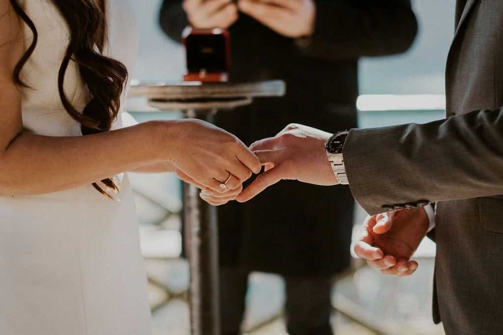 A bride and groom exchange rings during a wedding ceremony.