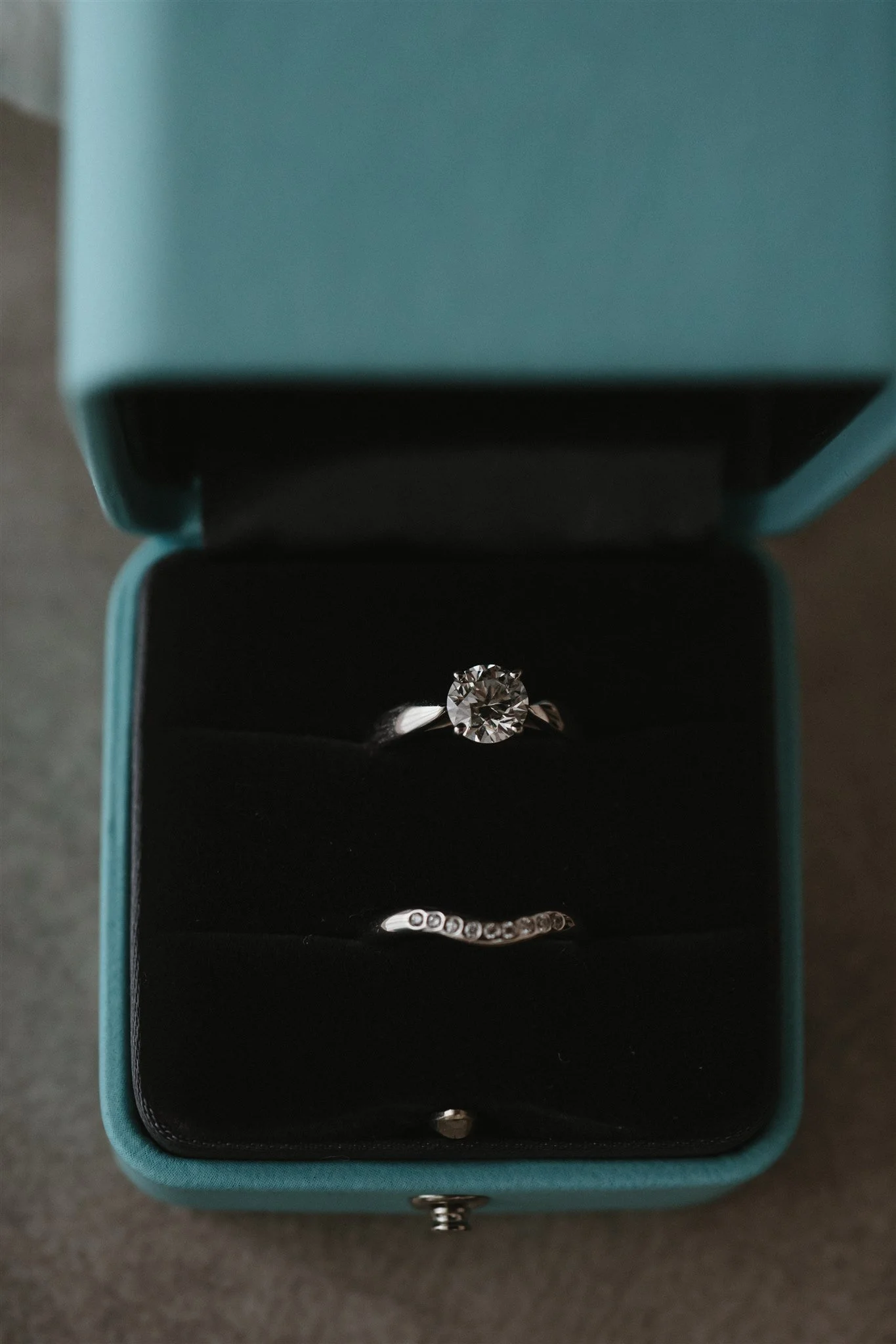 Open jewelry box containing a diamond ring and a diamond bracelet.