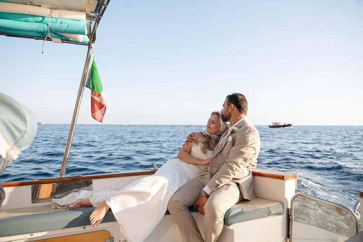 A couple relaxing on a boat on the Amalfi Coast